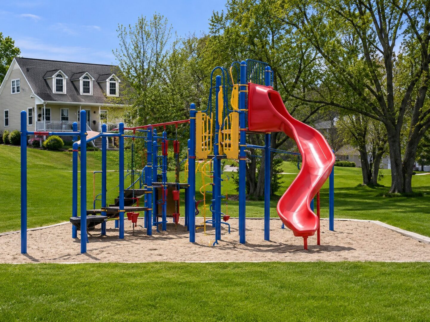 Playground with slide in a park setting.