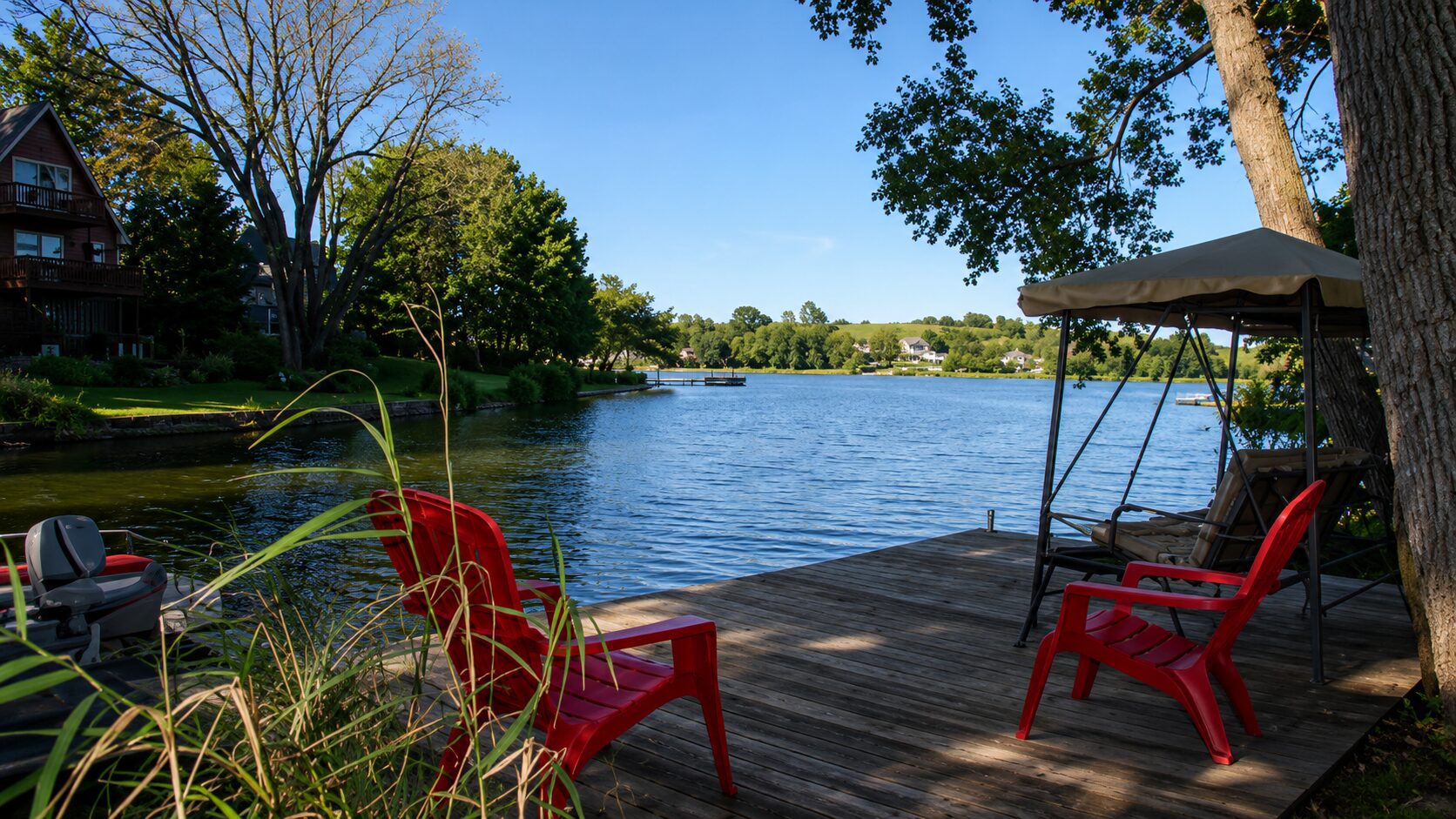 Lakeside deck with red chairs and canopy.