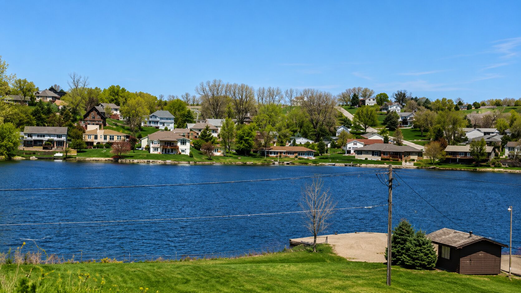 Lakeside houses with blue sky background.