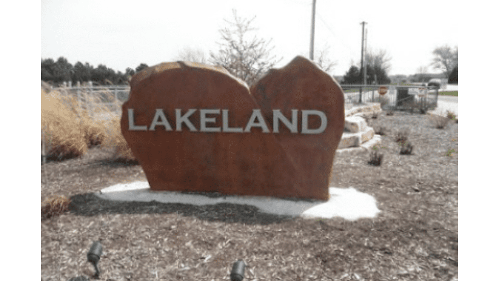 Lakeland sign on large rock formation.