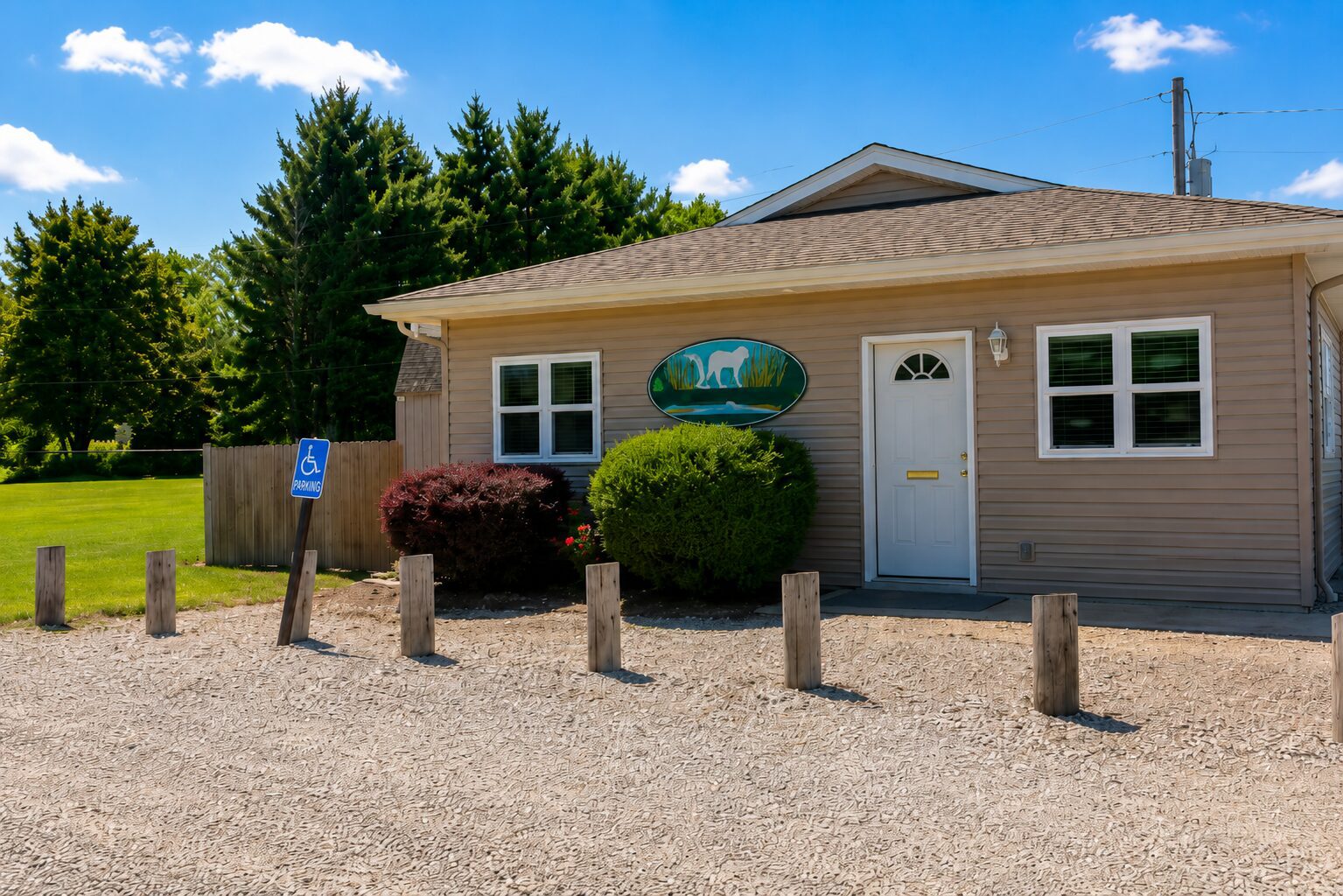 Small building with gravel parking area.