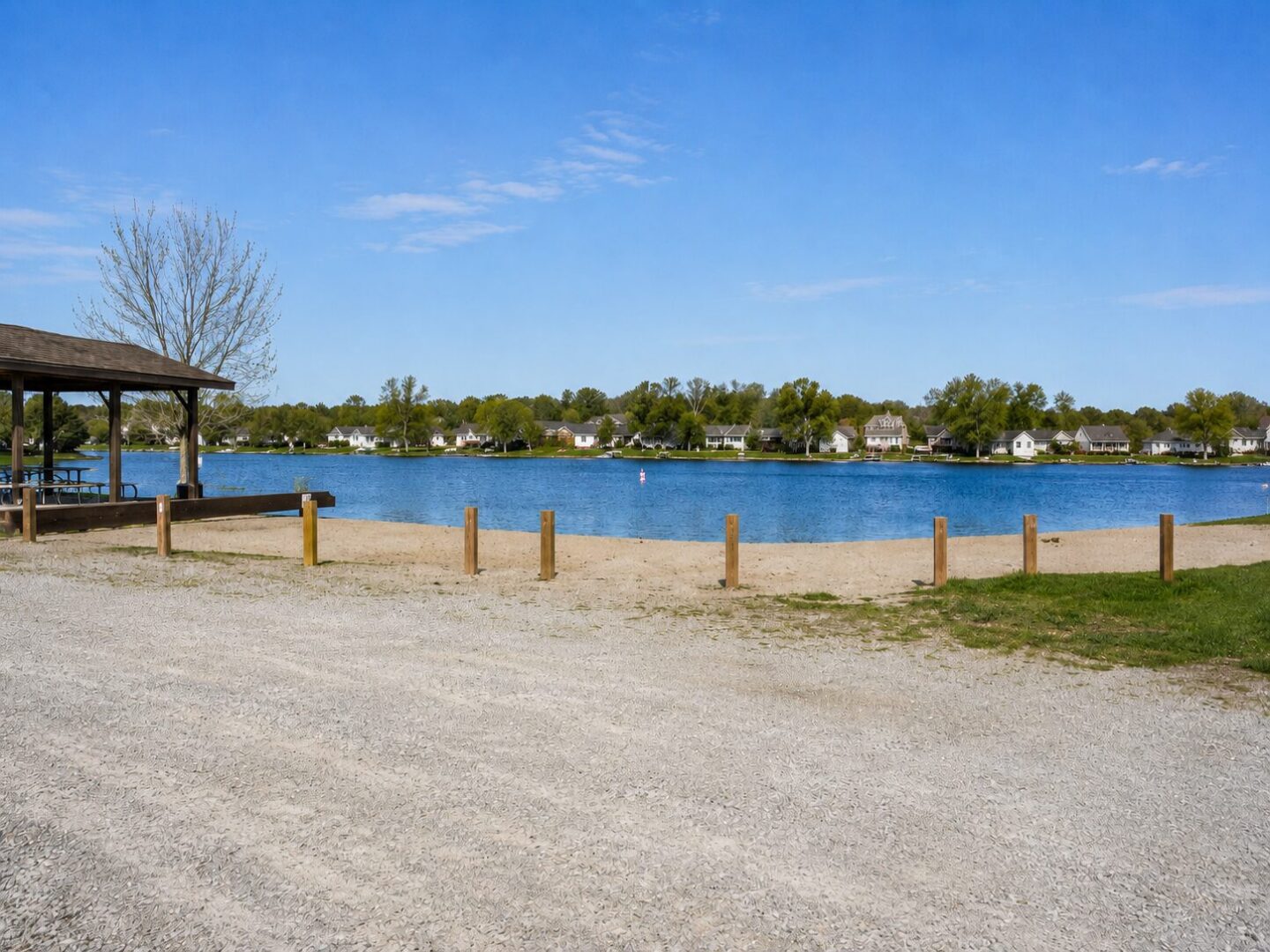 Lakeside view with clear blue sky.