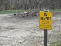 No dumping sign near scattered debris.