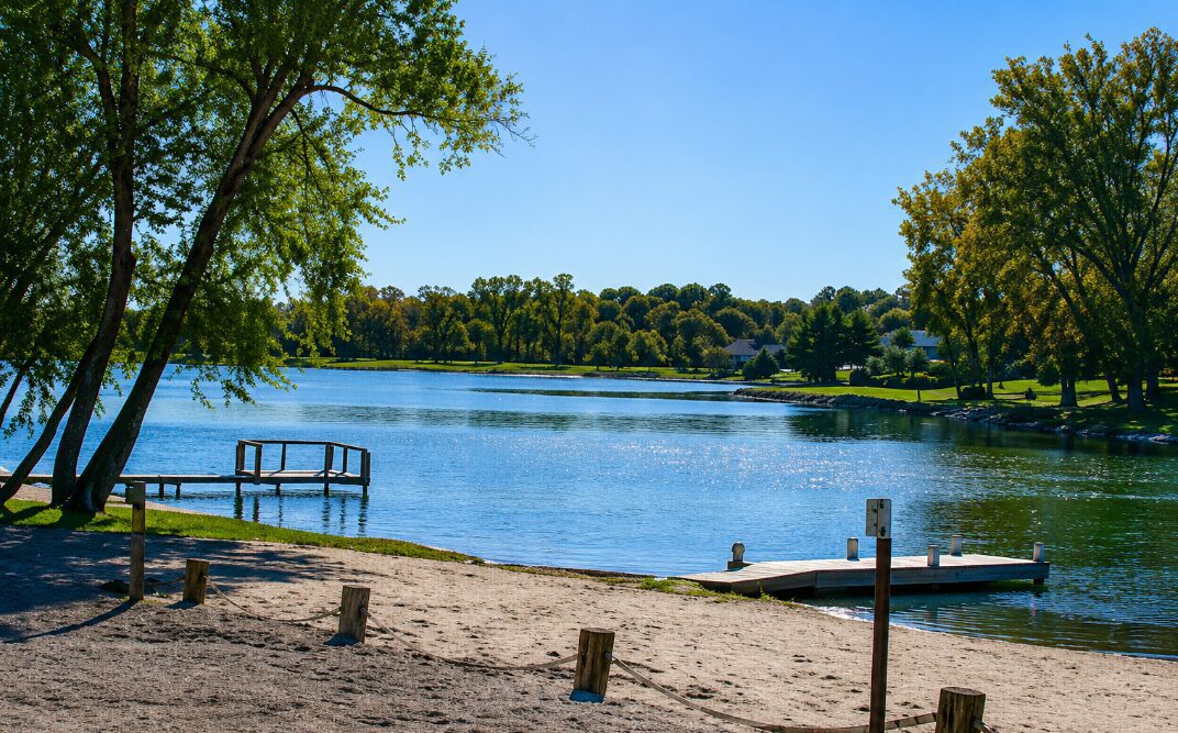 Lake with trees and small wooden docks.